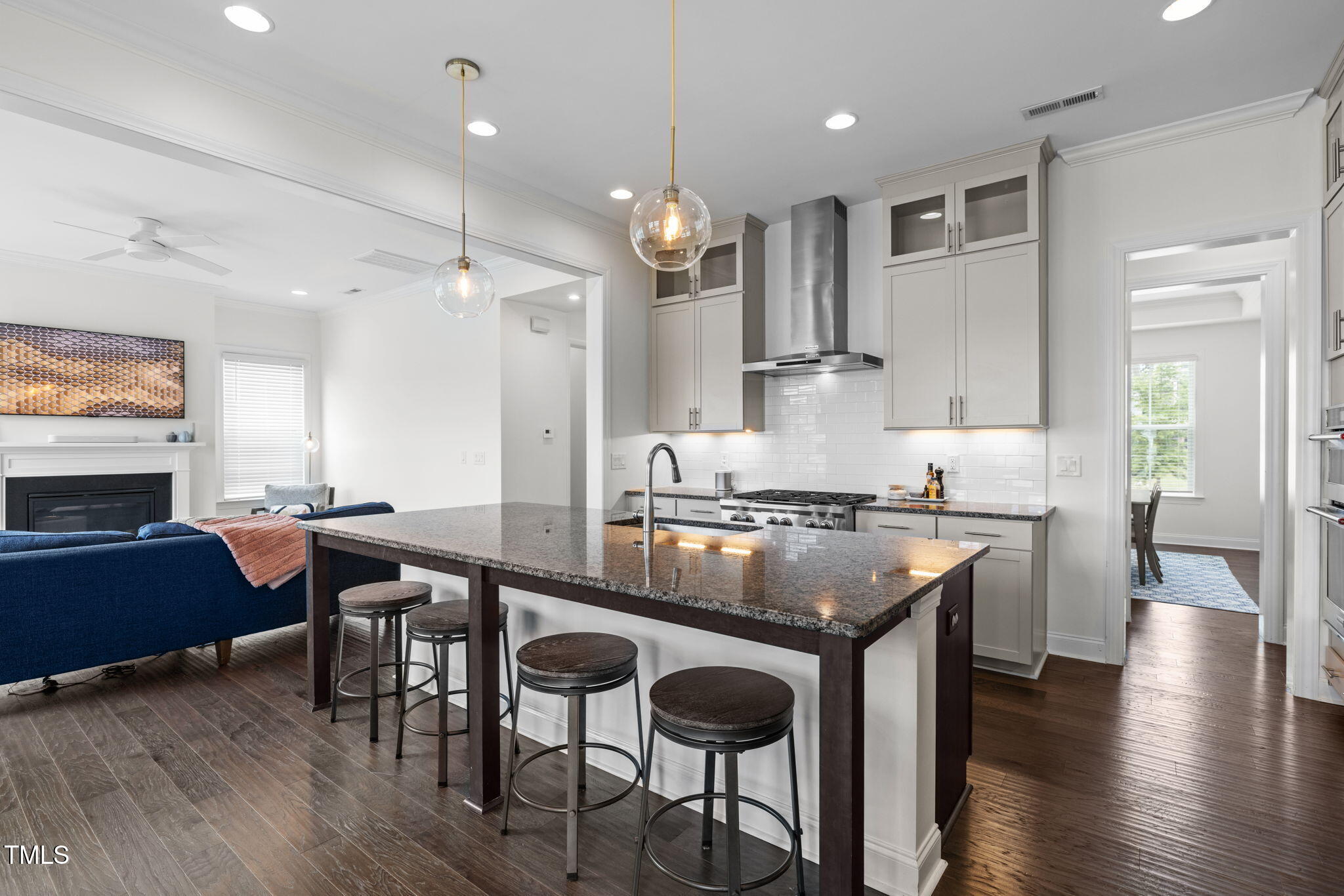 1606 Spring Overlook Lane Hillsborough, NC 27278 - Photo 14 of 56 a kitchen with granite countertop a stove a sink a dining table and chairs