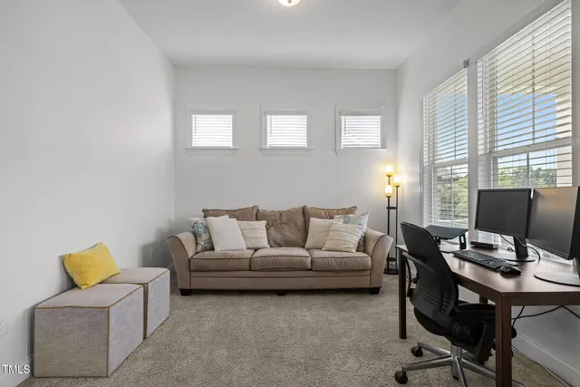 a view of a livingroom with furniture and hardwood floor