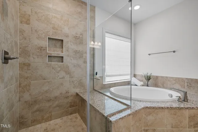 a bedroom with furniture and a window