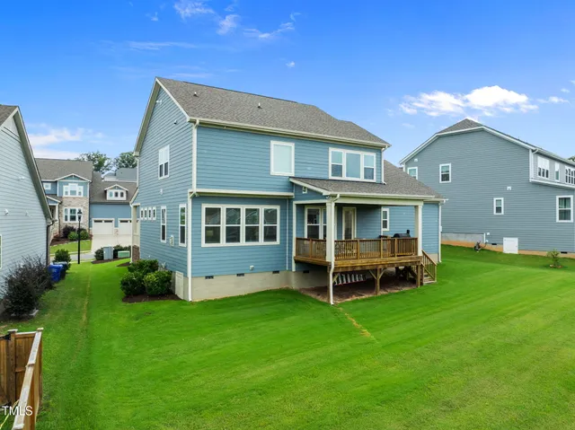 a view of a house with a backyard porch and sitting area