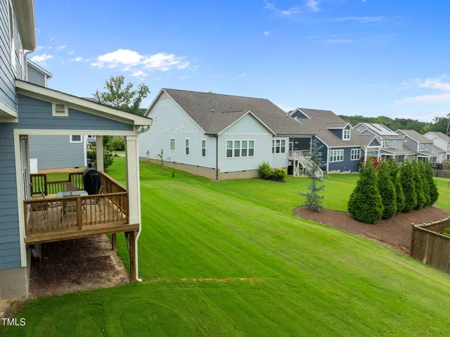 an aerial view of a house with a garden and houses