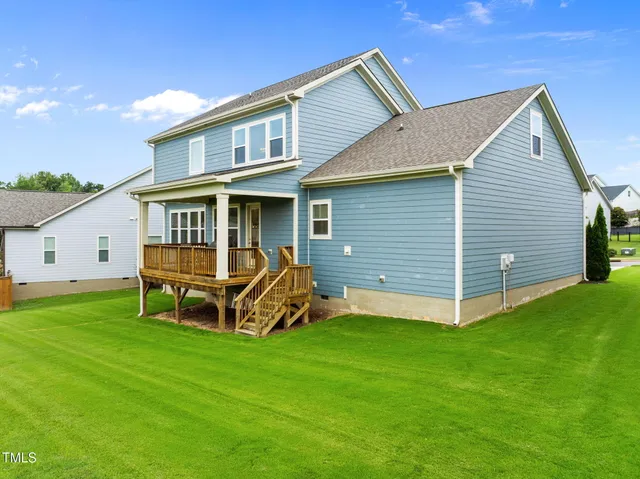 an aerial view of residential houses with outdoor space and parking