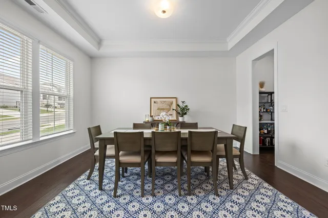a view of a dining room with furniture and a window