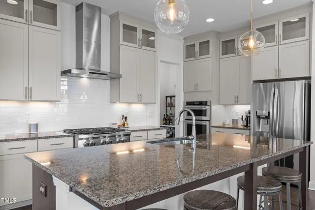 a kitchen with a sink stove and refrigerator