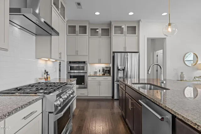a stove top oven sitting inside of a kitchen