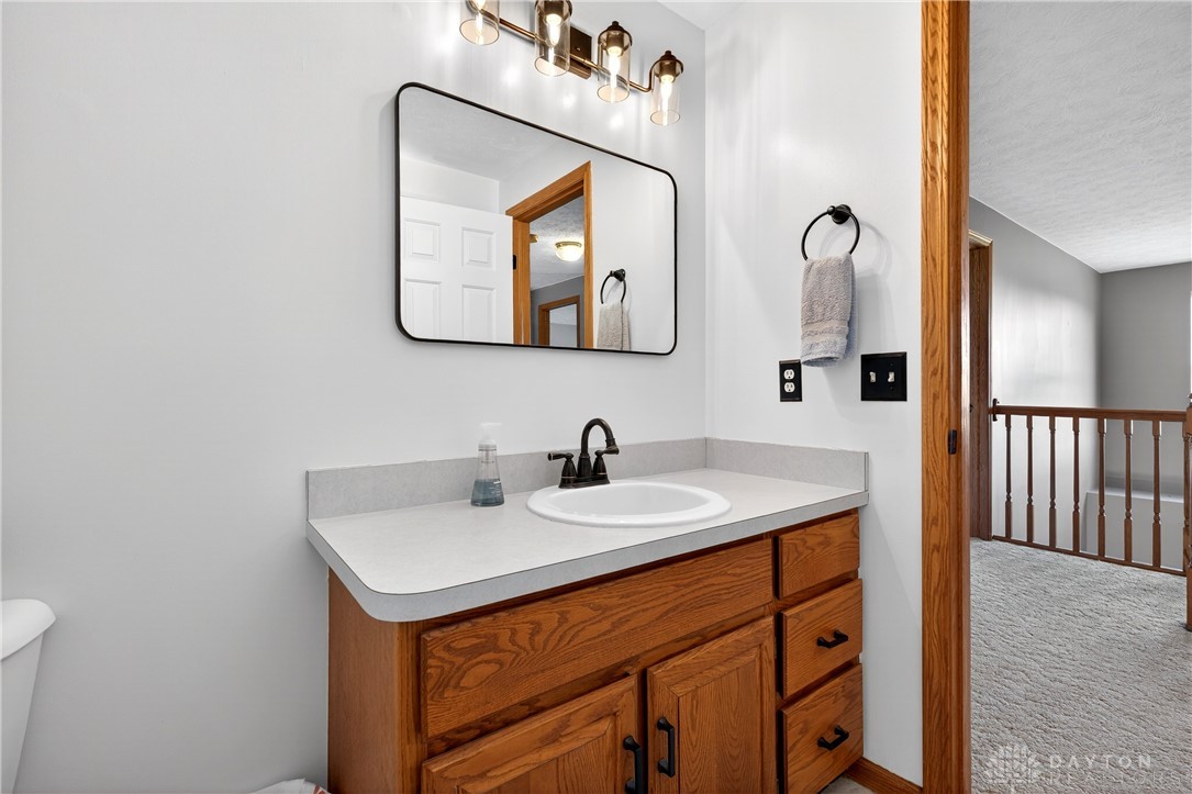 6560 Snyder Road Fletcher, OH 45326 - Photo 43 of 71 This clean and inviting bathroom features a vanity with a modern sink and a large mirror.
