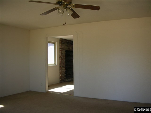 7575 Tholl Drive Reno, NV 89506 - Photo 3 of 6 an empty room with a empty space and chandelier fan