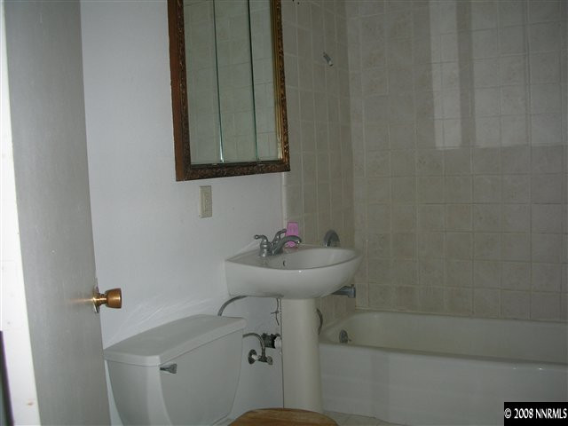 7575 Tholl Drive Reno, NV 89506 - Photo 4 of 6 a bathroom with a sink a toilet and a mirror