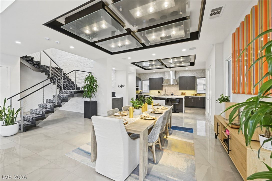 4208 Lapis Ridge Court Las Vegas, NV 89135 - Photo 9 of 61 Gleaming tile floors and architectural lighting panels define this modern open-concept space.