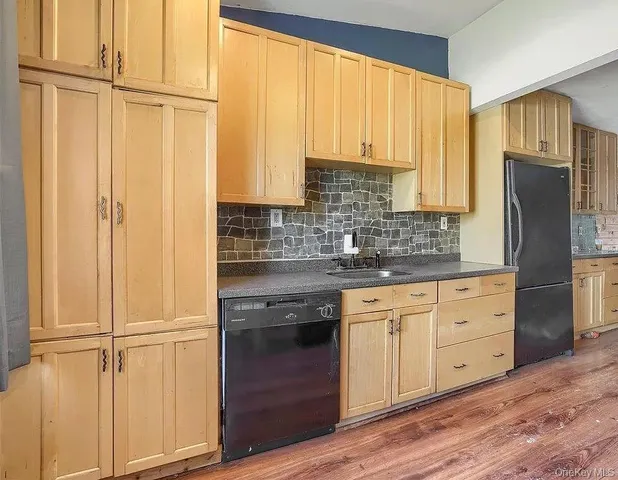 a kitchen with stainless steel appliances white cabinets and a window