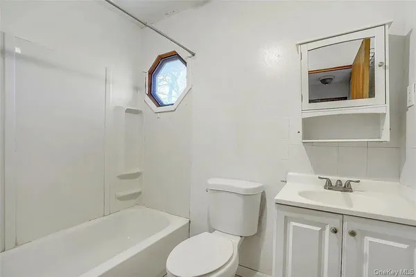 a white toilet sitting next to a bathroom sink