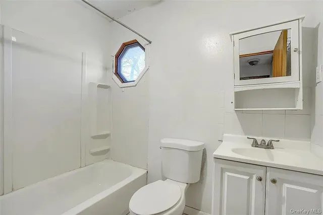 a white toilet sitting next to a bathroom sink