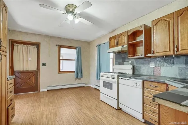a kitchen with stainless steel appliances granite countertop a stove and a sink