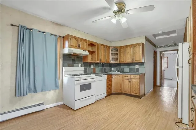 a kitchen with stainless steel appliances granite countertop a stove a refrigerator and a sink
