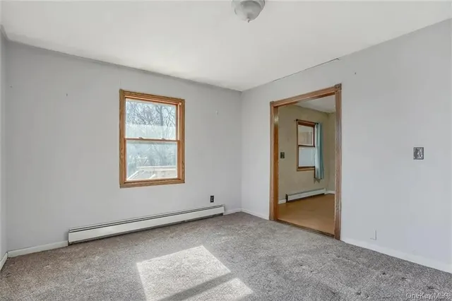 an empty room with windows and closet