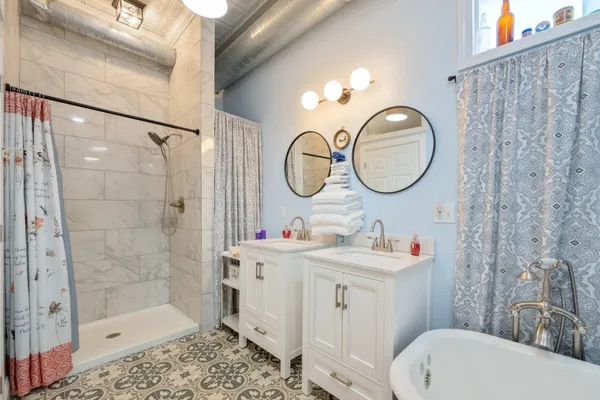 a bathroom with a sink mirror toilet and shower