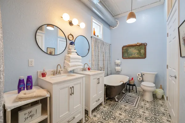 a bathroom with a toilet a sink and a mirror