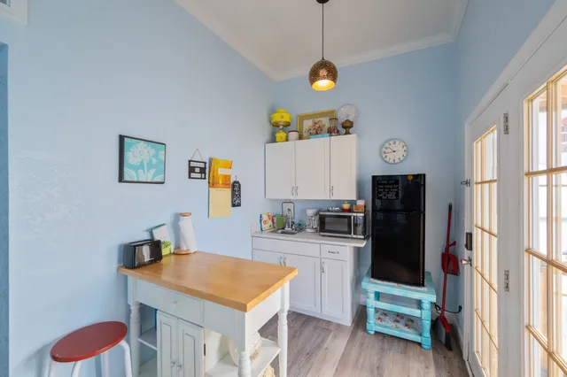 a view of a hallway that has a dining table and chairs
