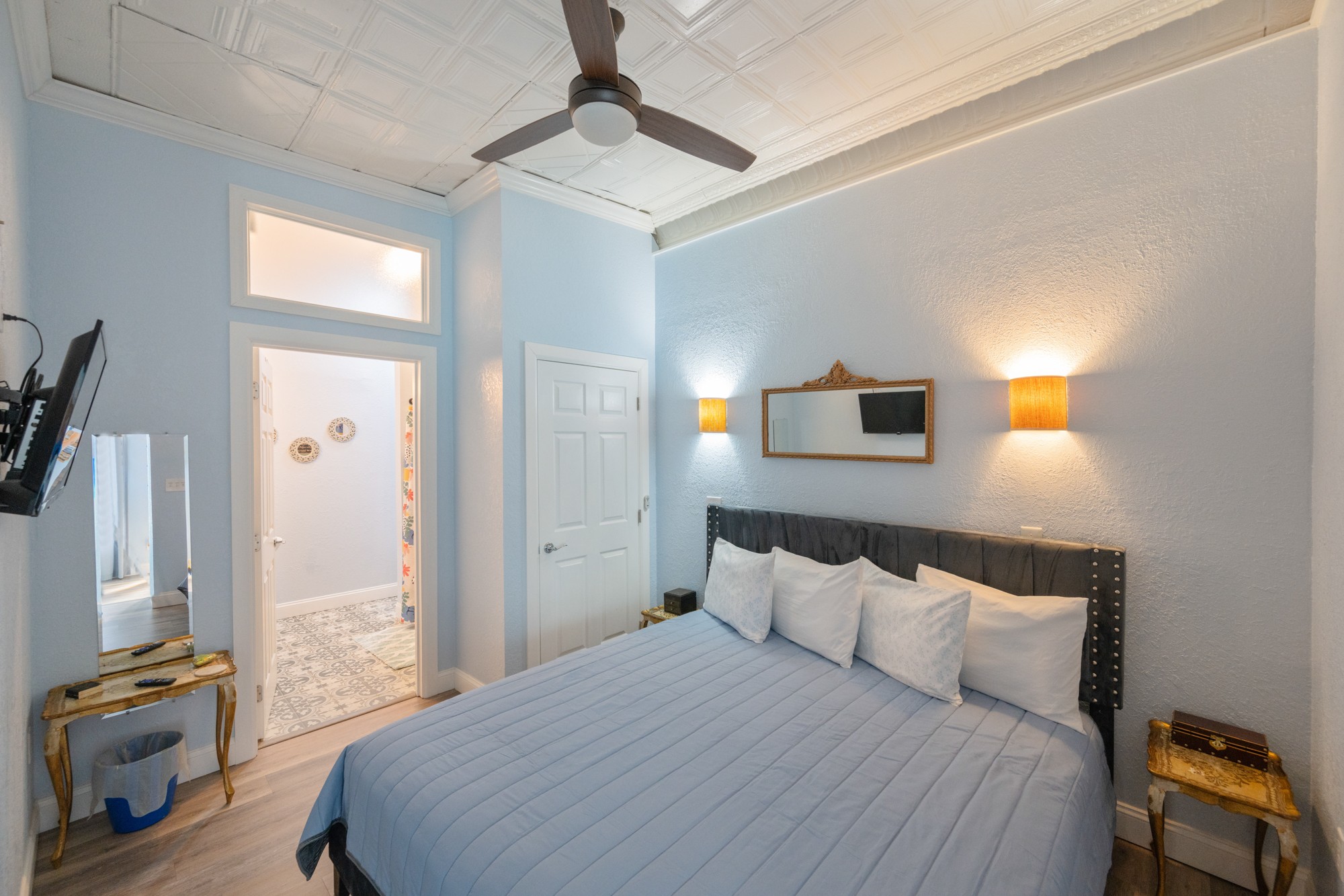 8 East Main Street Decaturville, TN 38329 - Photo 23 of 27 a bedroom with a bed a flat tv screen and a ceiling fan