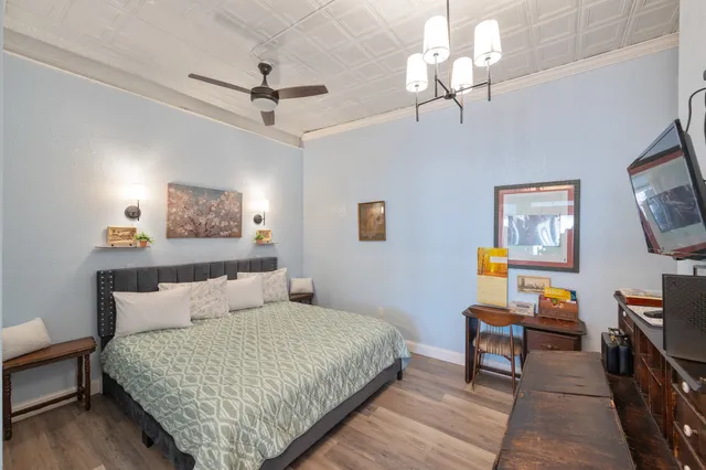 a bedroom with a bed bookshelf and a chair