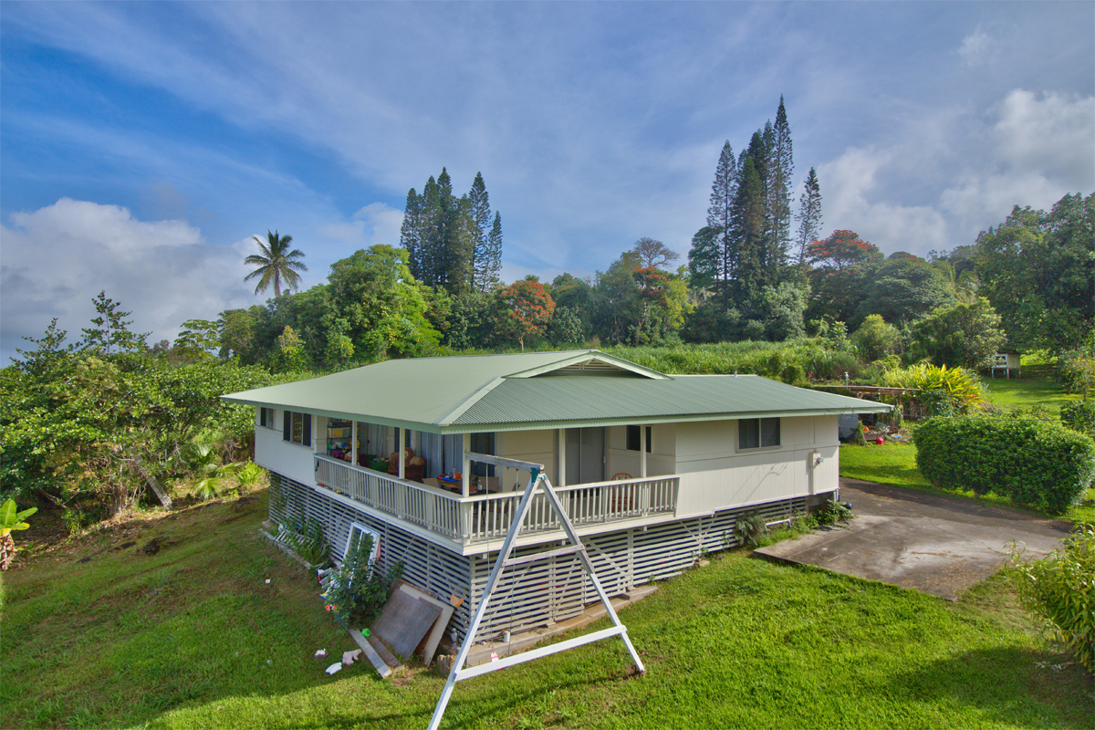 82-1019 KOA Road Captain Cook, HI 96704 - Photo 3 of 17 a white house with a big yard plants and large trees