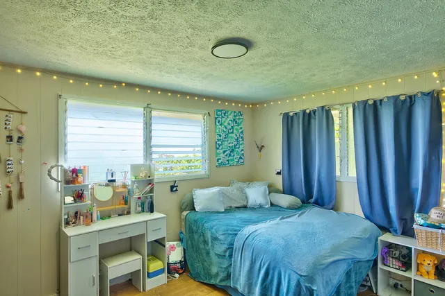 a spacious bedroom with a bed and a table