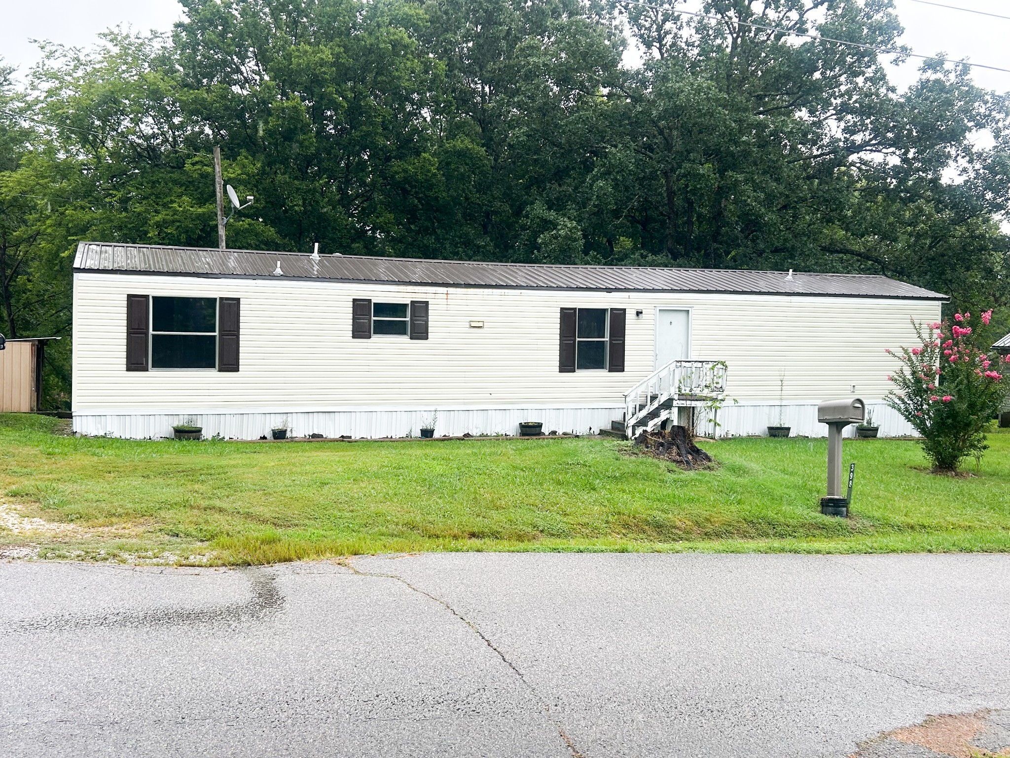 398 2nd Street Big Sandy, TN 38221 - Photo 1 of 26 a front view of a house with garden