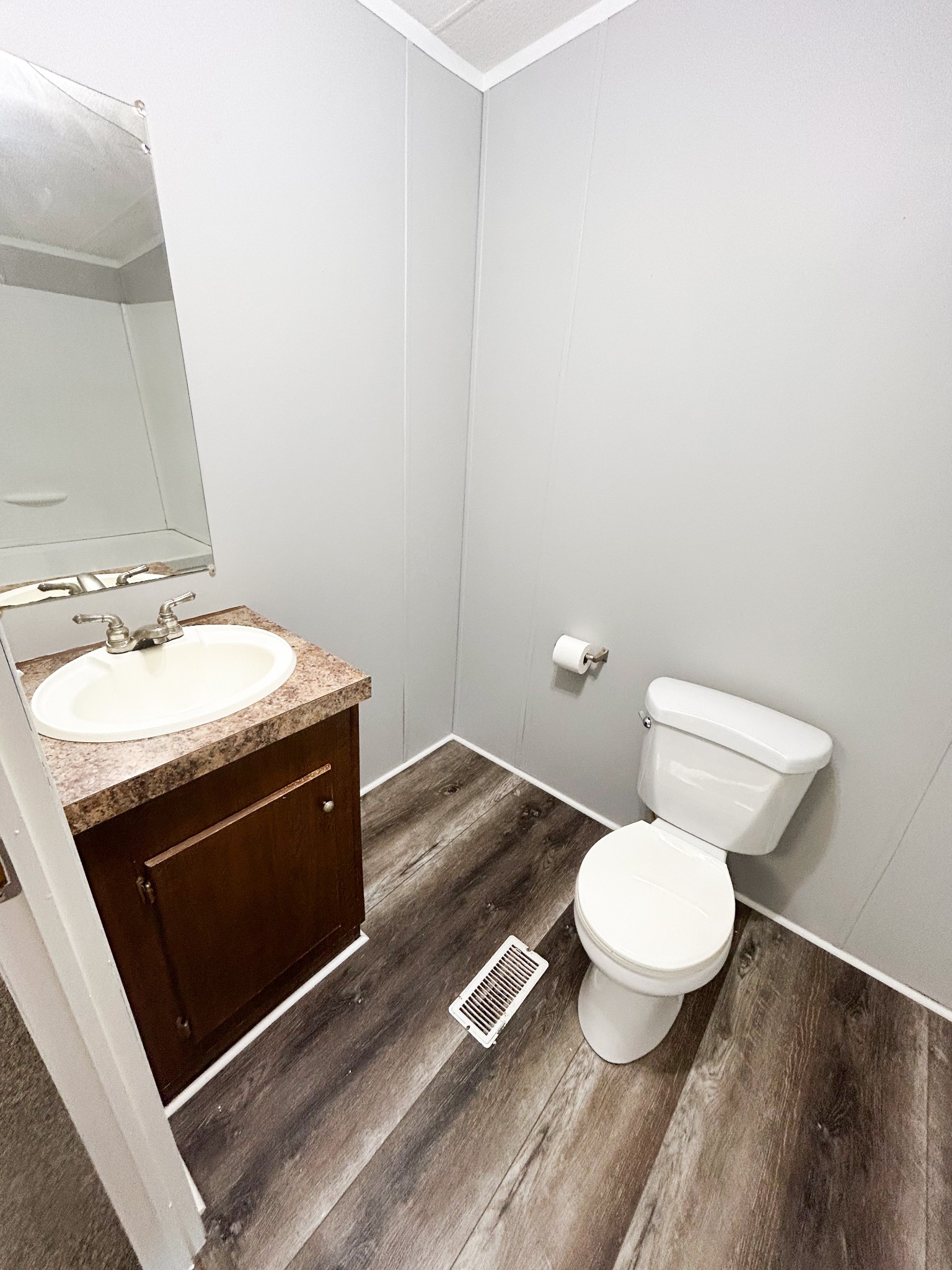 398 2nd Street Big Sandy, TN 38221 - Photo 20 of 26 a bathroom with a granite countertop toilet and a sink