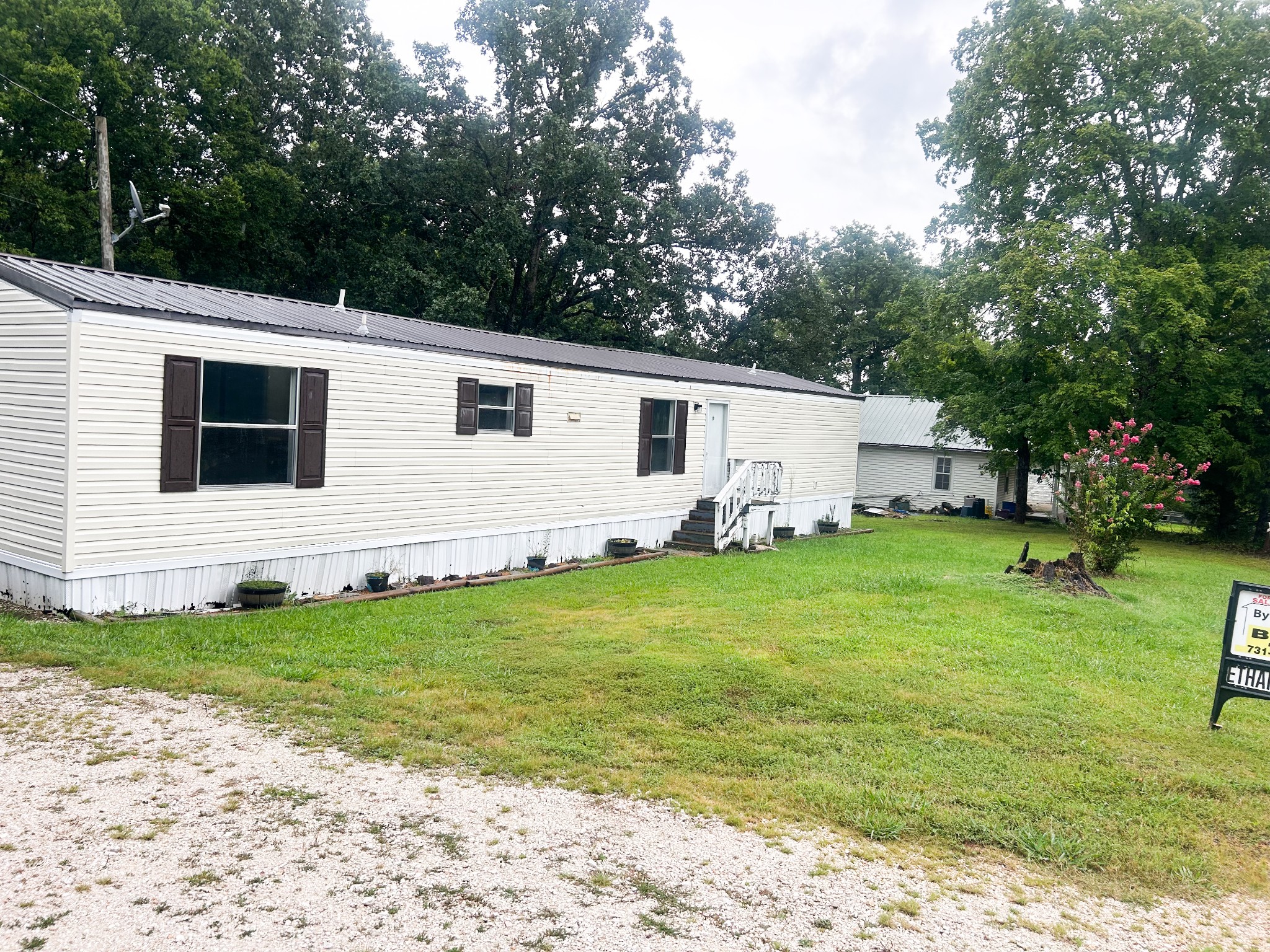 398 2nd Street Big Sandy, TN 38221 - Photo 6 of 26 a view of a house with a backyard