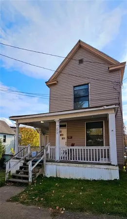 a view of a house with a yard and a garden
