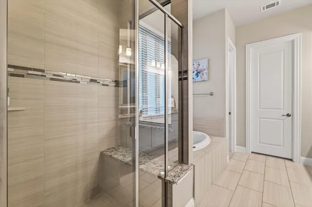 a bathroom with a shower and a sink