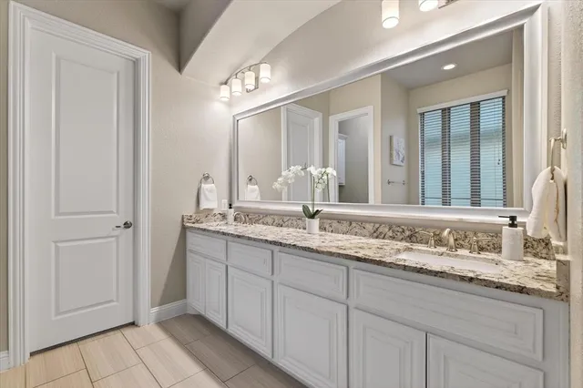 a bathroom with double sink and a mirror