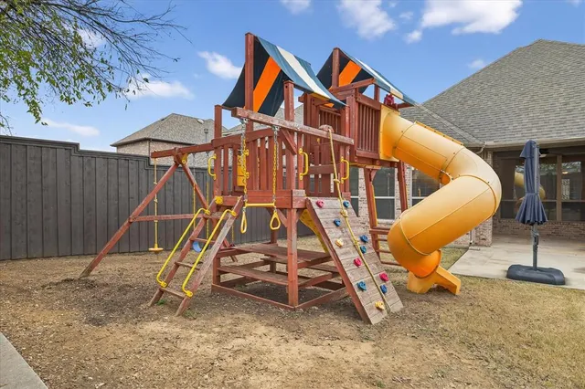 a view of a backyard with a table and chairs