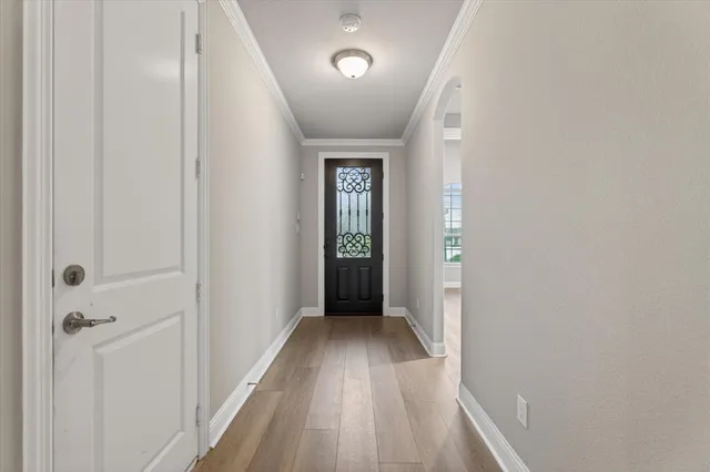 a view of a hallway with wooden floor