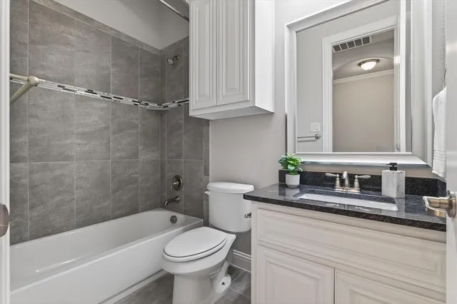 a bathroom with a bathtub a sink a toilet and a mirror