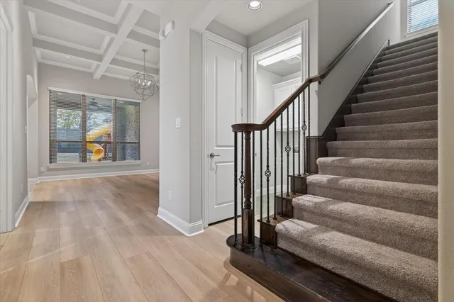 a view of an entryway with wooden floor and door