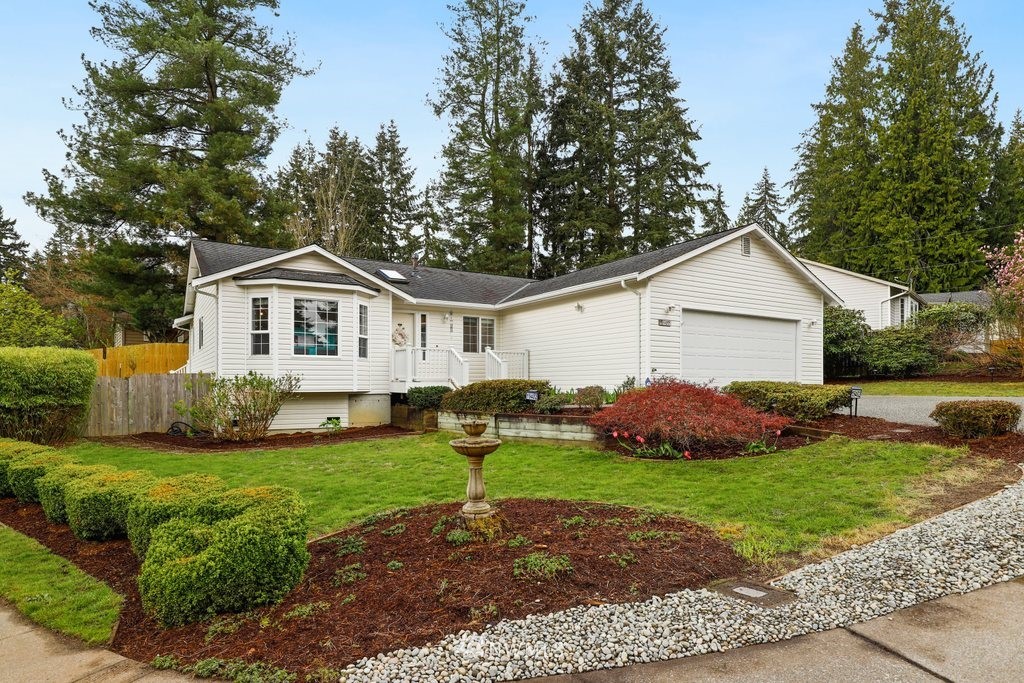 19402 Winesap Road Bothell, WA 98012 - Photo 2 of 35 a front view of a house with a yard and garage