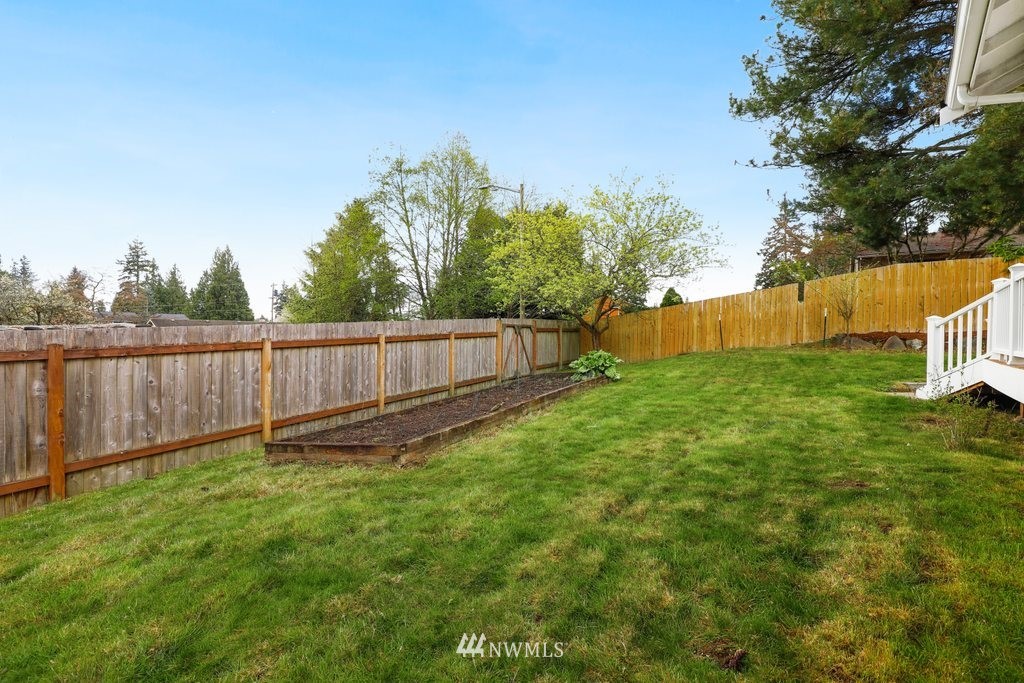 19402 Winesap Road Bothell, WA 98012 - Photo 23 of 35 a view of a backyard with wooden fence