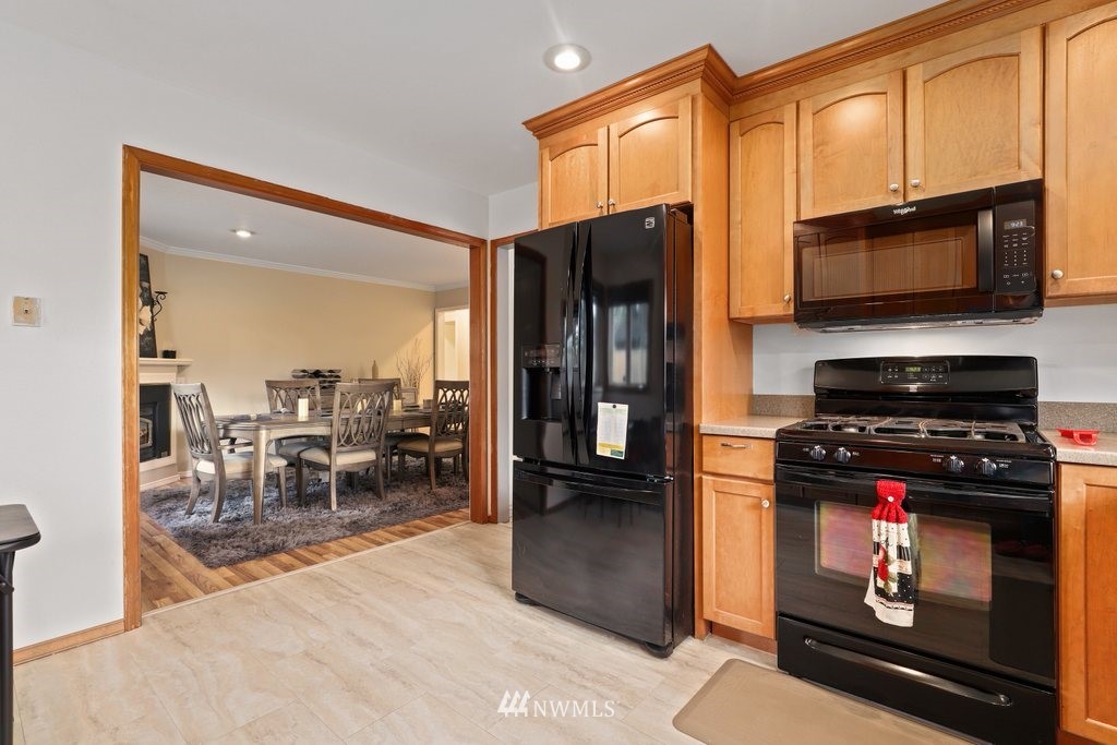 19402 Winesap Road Bothell, WA 98012 - Photo 8 of 35 a kitchen with stainless steel appliances a stove refrigerator and microwave