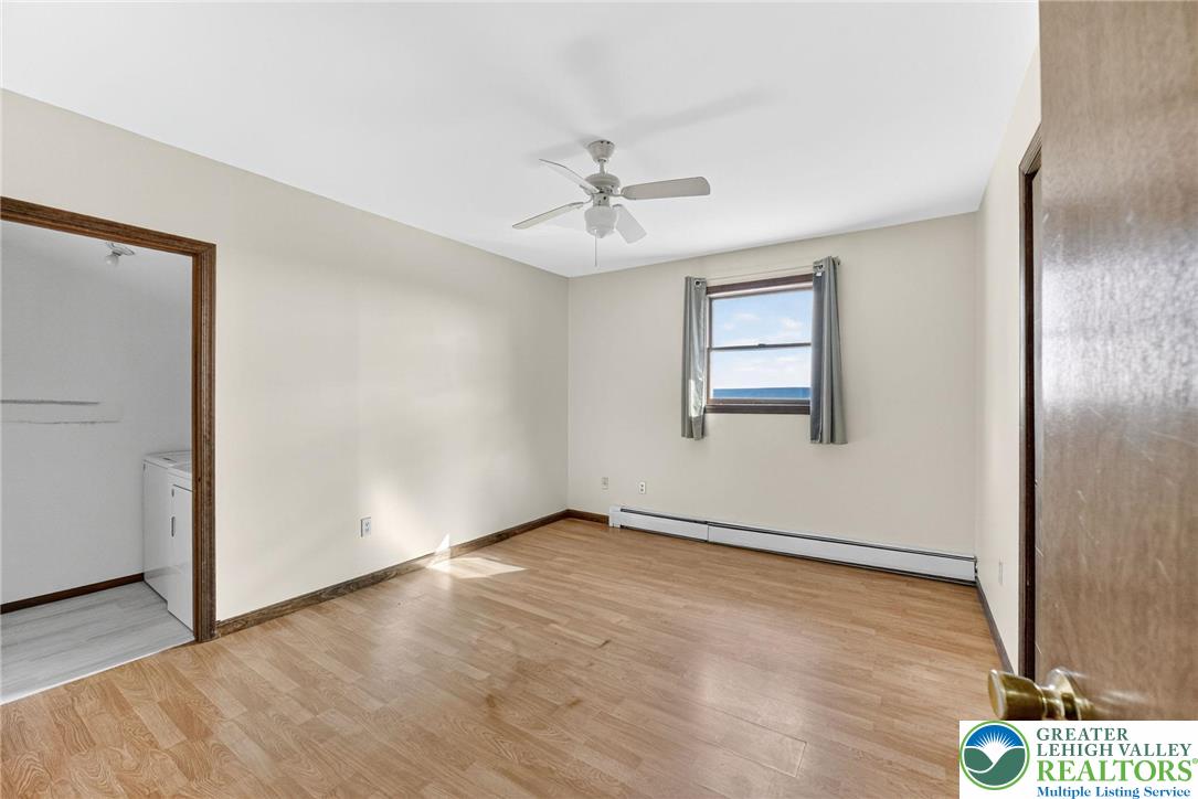 394 Flagstaff Road Lehighton, PA 18235 - Photo 24 of 75 an empty room with wooden floor chandelier fan and windows