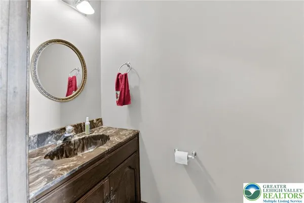 a bathroom with a sink a mirror and a shower