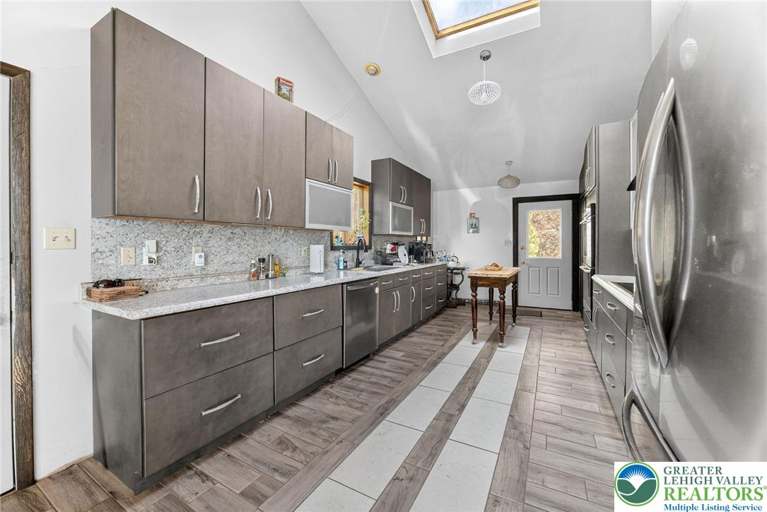 394 Flagstaff Road Lehighton, PA 18235 - Photo 41 of 75 a kitchen with stainless steel appliances granite countertop a sink refrigerator and cabinets