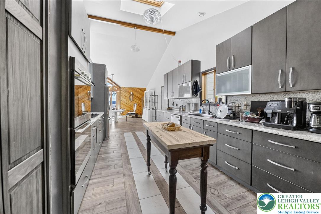 394 Flagstaff Road Lehighton, PA 18235 - Photo 43 of 75 a kitchen with stainless steel appliances granite countertop a refrigerator a sink dishwasher a stove and a microwave oven with white cabinets