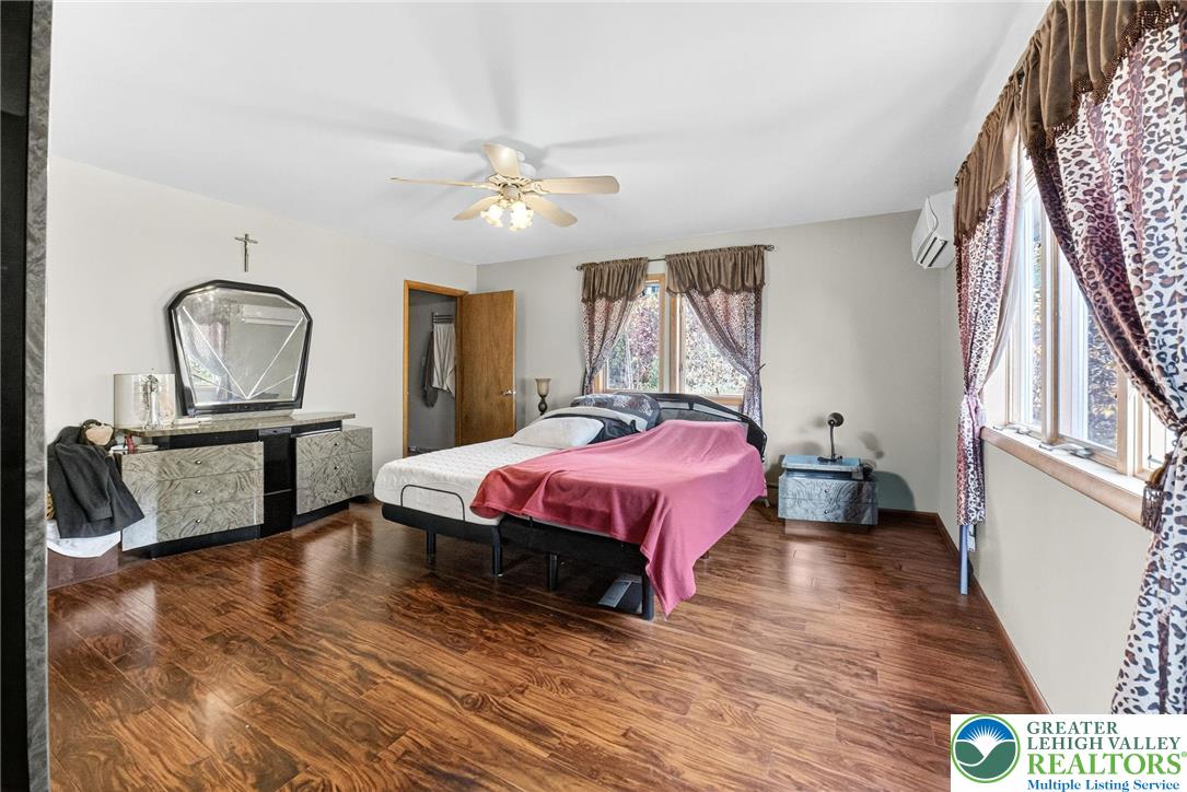 394 Flagstaff Road Lehighton, PA 18235 - Photo 48 of 75 a spacious bedroom with a bed a chandelier with dresser and mirror