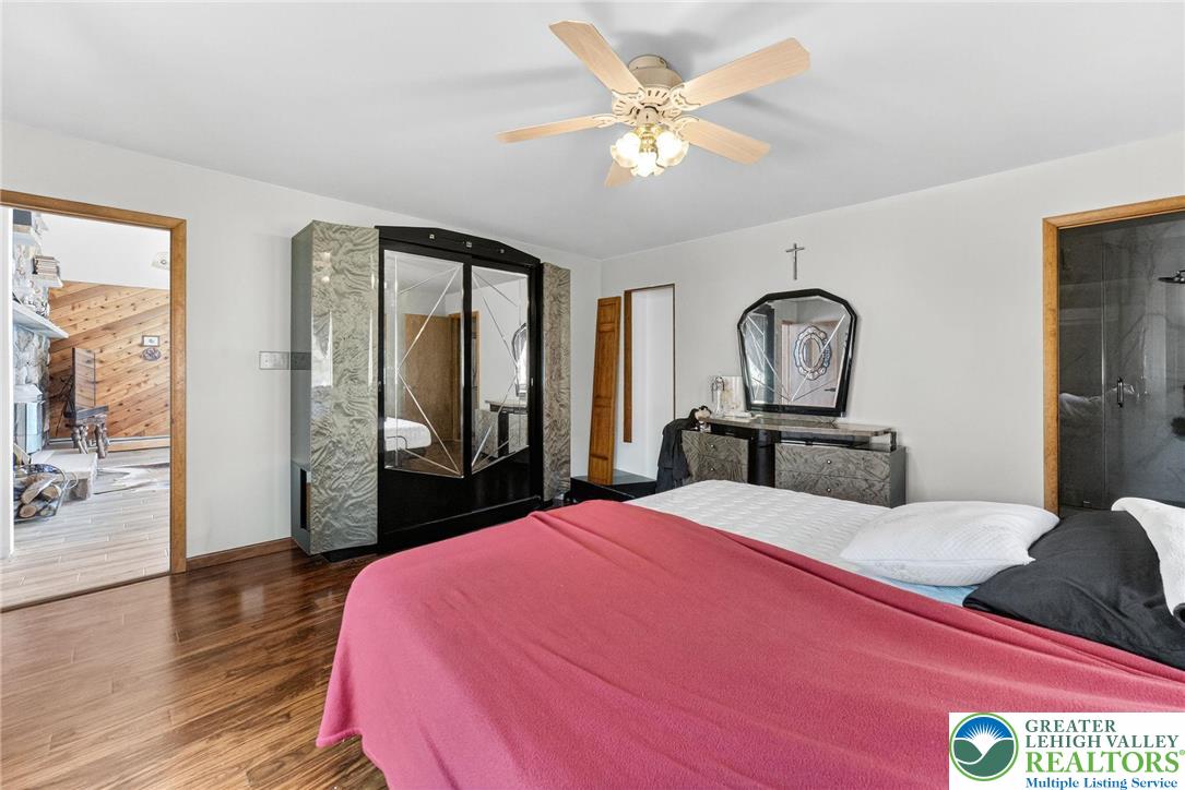 394 Flagstaff Road Lehighton, PA 18235 - Photo 49 of 75 a bedroom with a large bed and a chandelier