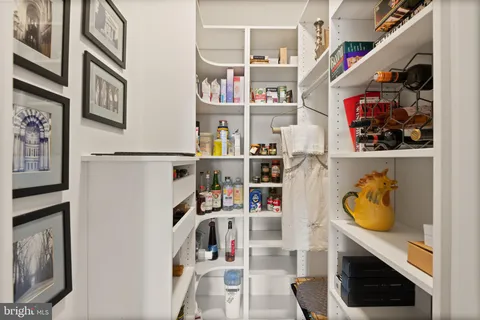 a bedroom with a bed and a flat tv screen on the dresser