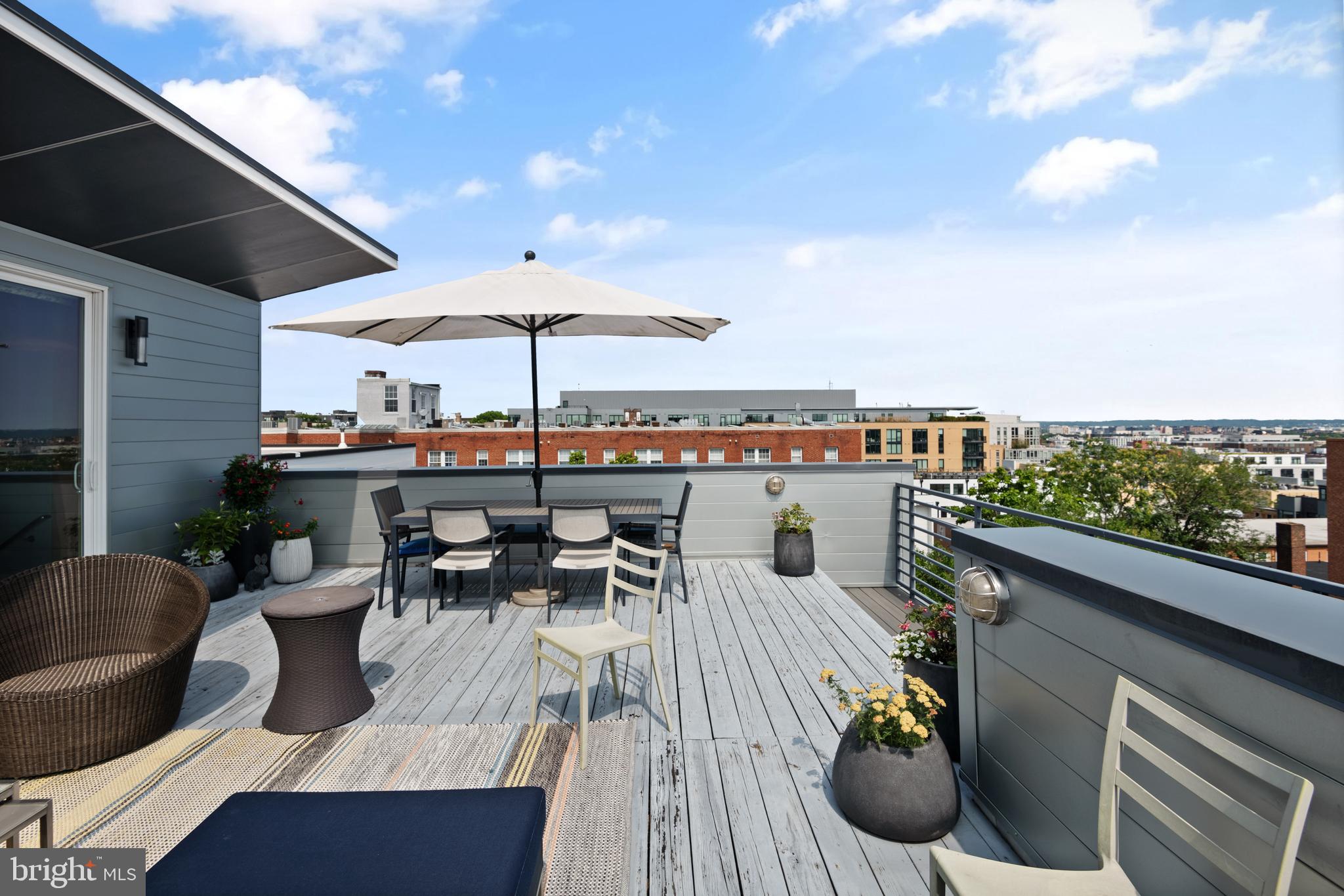 1436 Chapin Street Northwest, Unit F Washington, DC 20009 - Photo 40 of 41 a view of a balcony with table and chairs under an umbrella