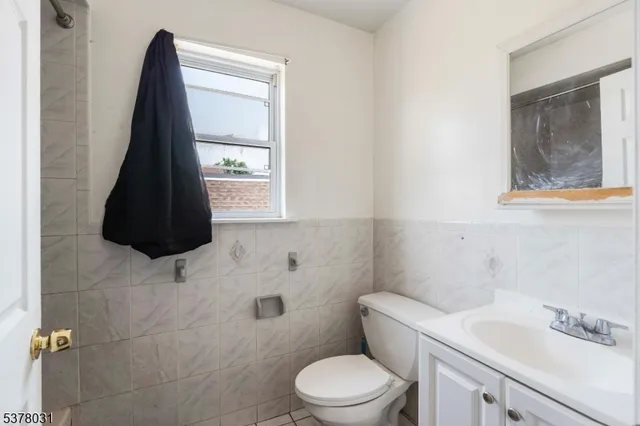 a bathroom with a sink a toilet and a shower