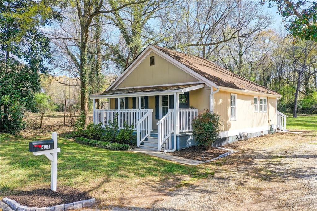 411 Ash Street Monroe, GA 30655 - Photo 2 of 36 a view of a house with a yard and large tree
