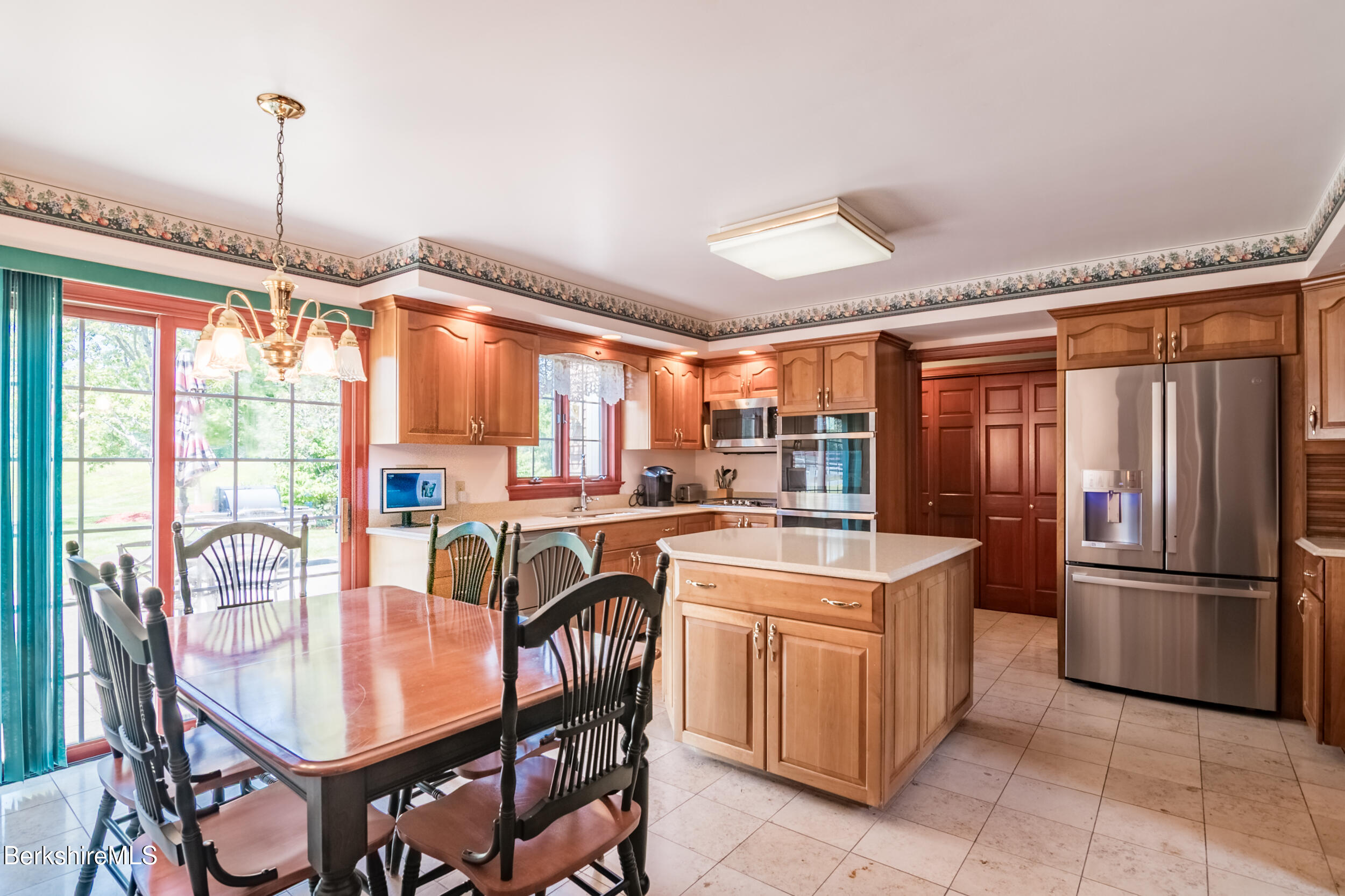 31 N Road Chesterfield, MA 01012 - Photo 21 of 50 a kitchen with stainless steel appliances granite countertop a stove top oven a refrigerator and a dining table with a large window